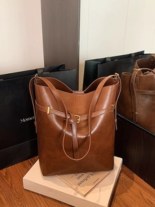 Brown vintage PU leather bucket tote bag with gold buckle detail for daily commute
