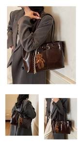 Detailed views of dark brown tote bag with decorative bear charm and metal buckle