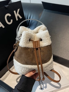 Plush lamb wool and brown suede bucket bag with metal ring handle and drawstring