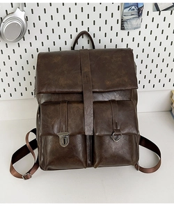 Detail of vintage dark brown faux leather backpack with double front buckle pockets