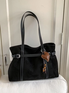 Black suede tote bag with contrast stitching and wooden bead heart charm decoration
