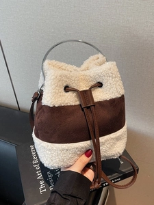 Chic winter drawstring bucket bag in beige faux shearling and brown suede with metal ring handle
