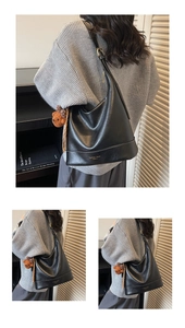 Detail view of black hobo bag with teddy charm and Fashion Trend lettering detail