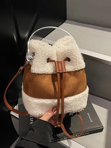 Fuzzy brown and white bucket bag with silver ring handle and adjustable strap
