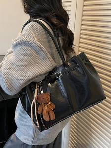 Retro black faux leather shoulder bag with silver buckle and brown teddy bear charm