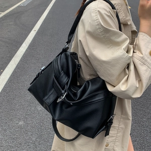 Retro black large capacity PU tote bag with knot detail worn by model in street view