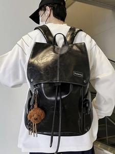 Large vintage black faux leather backpack with drawstring closure and teddy charm