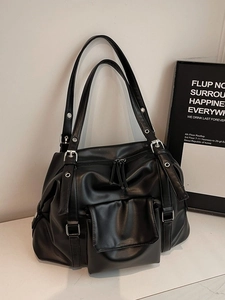 Retro black faux leather tote bag with silver eyelet accents and adjustable straps