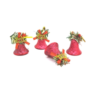 Detail of red Christmas bells with green pine needles and Merry Christmas bows