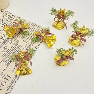 Detail of 5 golden Christmas angel bells with green pine needles and striped bows