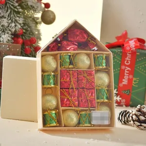 Detail of Christmas ornament set with gold balls and green drums in a house-shaped box