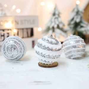Sparkling silver Christmas balls with white foam patterns and silver loops for tree decor
