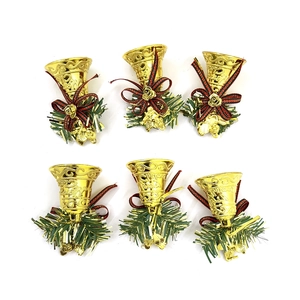 Set of 6 gold Christmas bells with bows, pine needles and angel pendants on white background