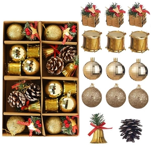 Christmas tree decoration set with golden balls, bells and pine cones in a kraft box