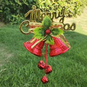 Christmas decoration featuring golden Merry Christmas lettering and red jingling bells
