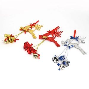Close-up of gold, red, and silver Christmas elk bell ornaments with glitter finish