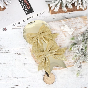 Close-up of sparkling gold glitter Christmas bows for festive gift box and tree decoration
