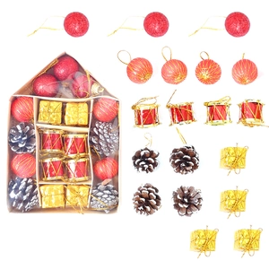 Christmas ornaments set with red baubles, golden gift boxes and cones in house-shaped box