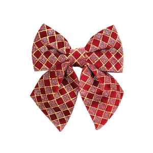 Detail of red Christmas bow with golden diamond patterns for holiday tree decoration
