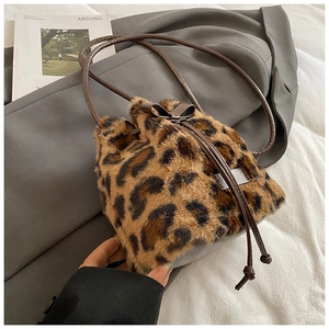 Close-up of leopard print faux fur bucket bag with drawstring closure and bow detail