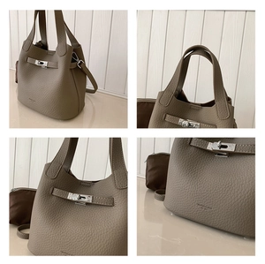 Macro detail of litchi grain leather texture and metal hardware on a bucket bag