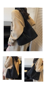 Detail view of large black matte faux leather hobo shoulder bag with wide strap