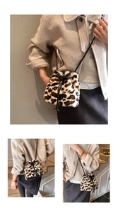 Detail view of leopard print faux fur bucket bag with black drawstring and slim strap