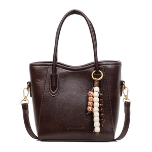Dark coffee vintage bucket bag in faux leather with gold hardware and beaded charm