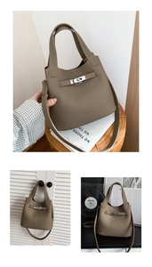 Macro view of dark taupe lychee pattern leather bucket bag with metal studs