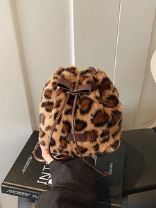 Winter faux fur leopard print bag with drawstring closure and leather bow detail