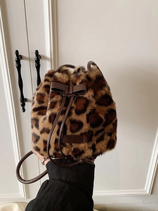 Plush leopard print faux fur bucket bag with brown bow and drawstring strap for winter