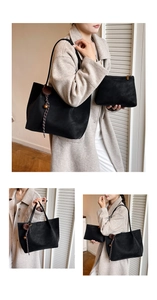 Detail of black tote bag set with matching pouch and decorative brown fur ball ornament