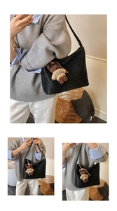 Close-up of black woven leather tote bag with a cute brown bear charm detail