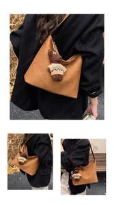 Detailed view of brown woven hobo bag featuring a cute teddy bear plush charm accessory