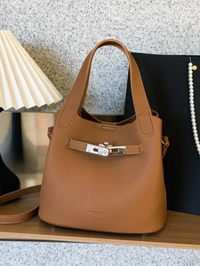 Brown litchi grain leather bucket bag with silver hardware and crossbody strap