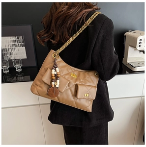 Detailed view of brown quilted chain shoulder bag with dual gold twist-lock pockets
