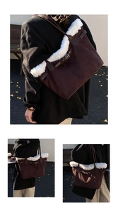 Detail of a brown suede tote bag with white faux fur trim and decorative leather buckle