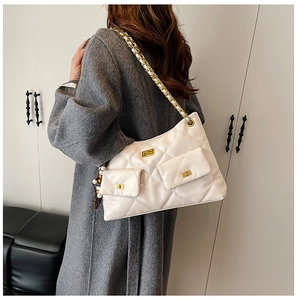 Detail of cream quilted shoulder bag with gold chain strap and two small coin pouches
