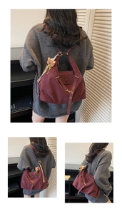 Detail of burgundy vintage backpack with cute bear pendant and magnetic flap closure
