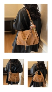 Detail of caramel suede tote bag with flap closure and cute bear plush charm accessory