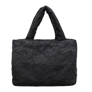Elegant black tote bag with floral jacquard texture and quilted handle for women