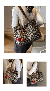 Detail of leopard print plush tote bag with woven strap and decorative fur pom-pom charm