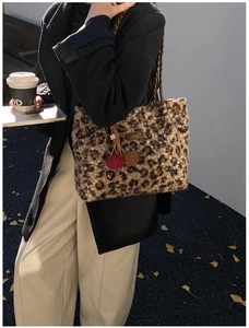 Fashionable leopard print plush tote bag with woven handles and pompom charm detail