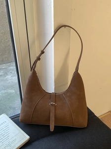 Vintage brown suede hobo bag with adjustable strap and metal buckle detail