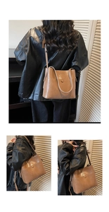 Detail of vintage brown leather bucket bag showing magnetic buckle and embossed lettering