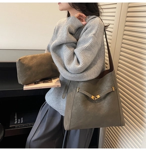 Detail view of large grey bucket bag and pouch set with gold buckle decoration
