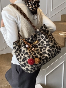 Women's leopard print plush tote bag with woven chain strap and decorative pompom charm