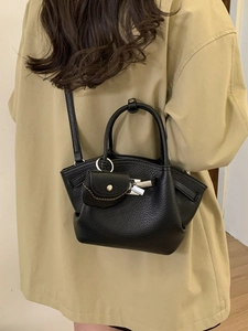 Minimalist black lychee pattern leather underarm bag with mini pouch worn by model