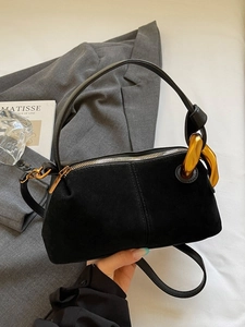 Fashionable black Boston pillow bag with suede patchwork and large gold chain hardware
