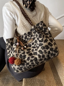 Chic leopard print plush tote bag with woven shoulder strap and decorative tassels